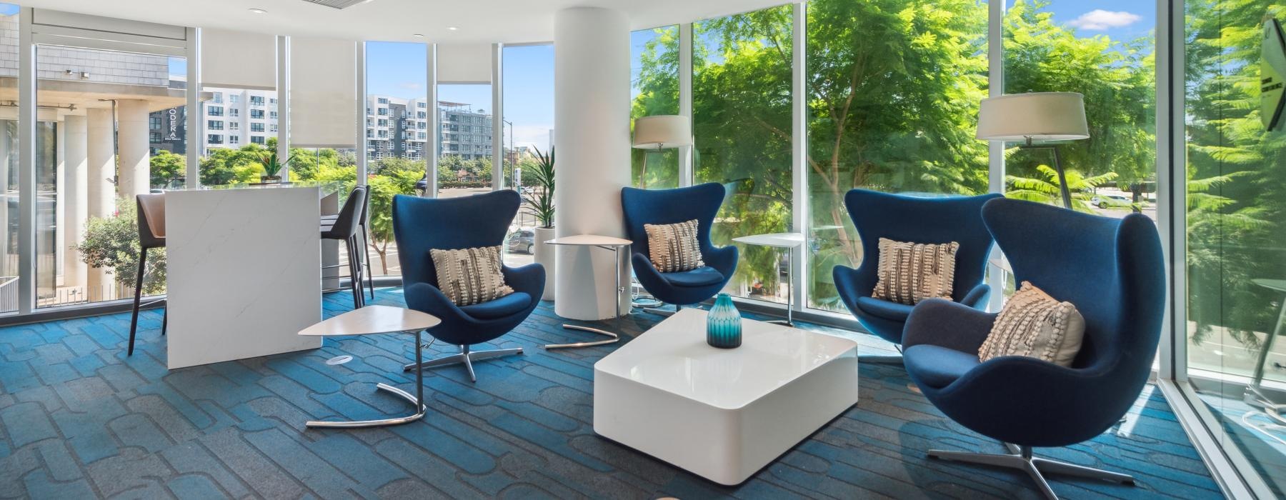 a room with a large glass wall and a table with chairs