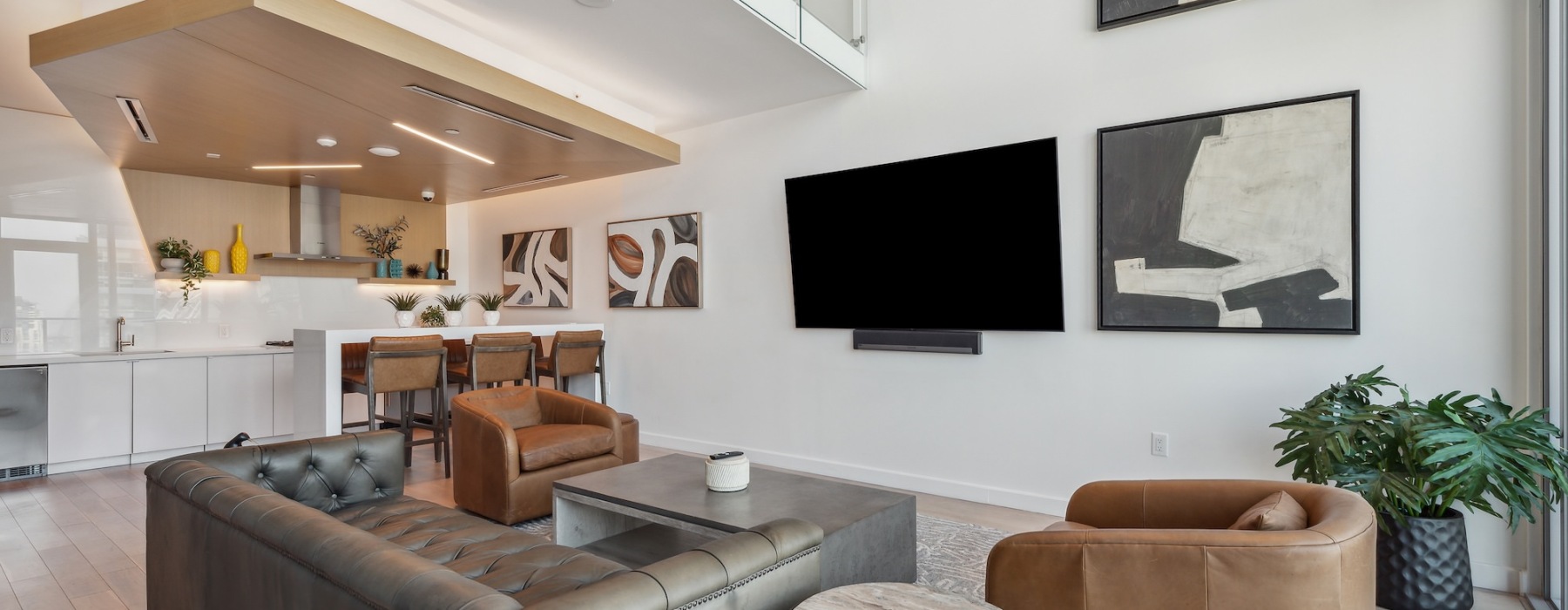a spacious lounge with a kitchen and couches