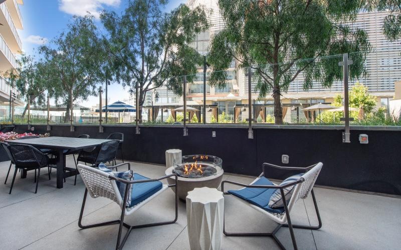 a firepit with lounge chairs around it