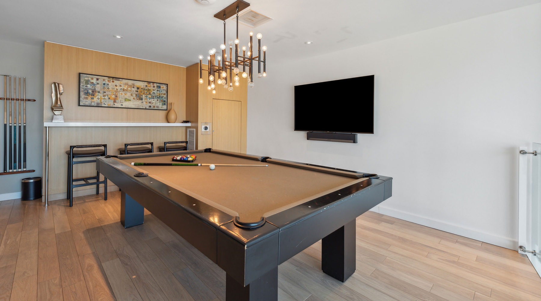 a room with a pool table and a tv on the wall